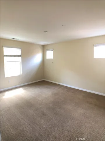 an empty room with a empty space and windows