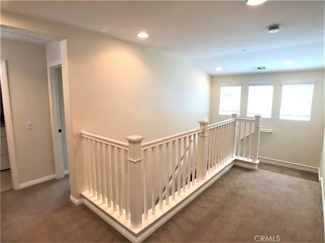 a view of a hallway with windows