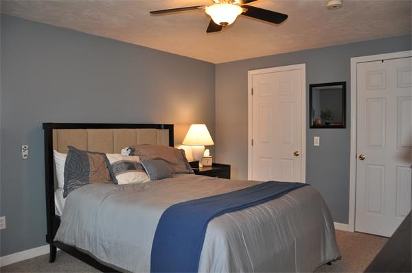24 1/2 Mason Road Dudley, MA 01571 - Photo 10 of 30 a bedroom with a bed and a chandelier
