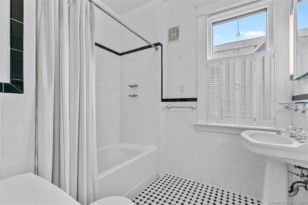 266 Everit Street New Haven, CT 06511 - Photo 11 of 21 a bathroom with a sink a mirror and a shower
