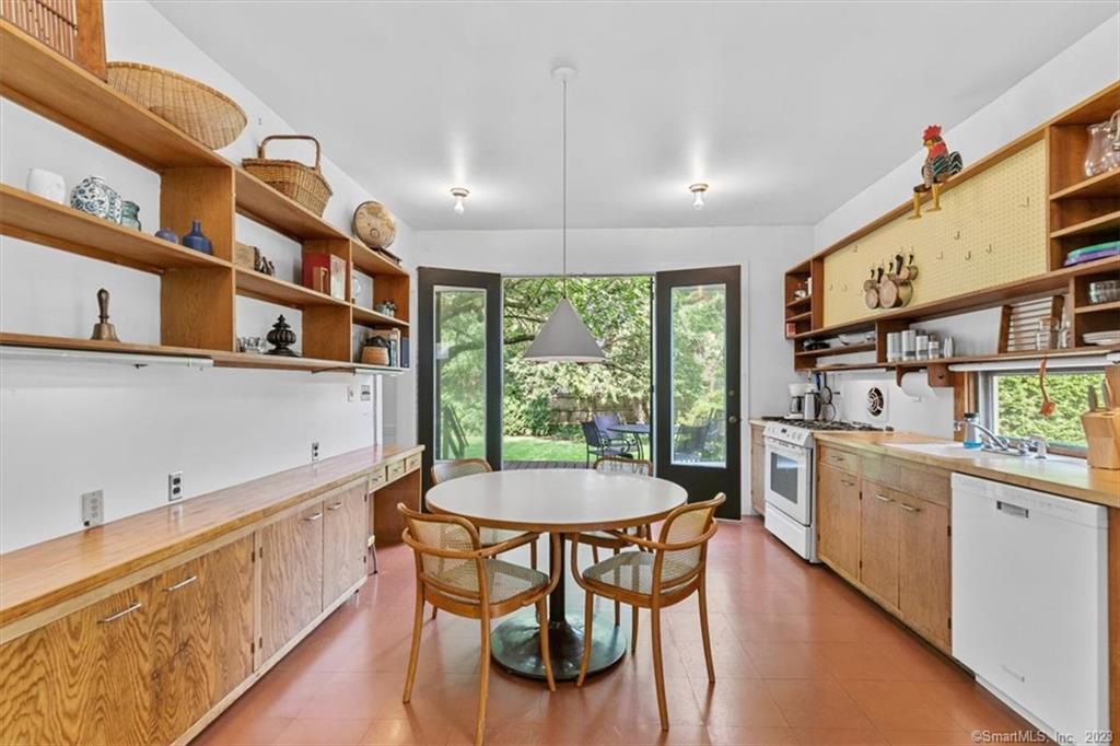 266 Everit Street New Haven, CT 06511 - Photo 5 of 21 a kitchen with stainless steel appliances granite countertop a stove a refrigerator a sink and white cabinets with wooden floor