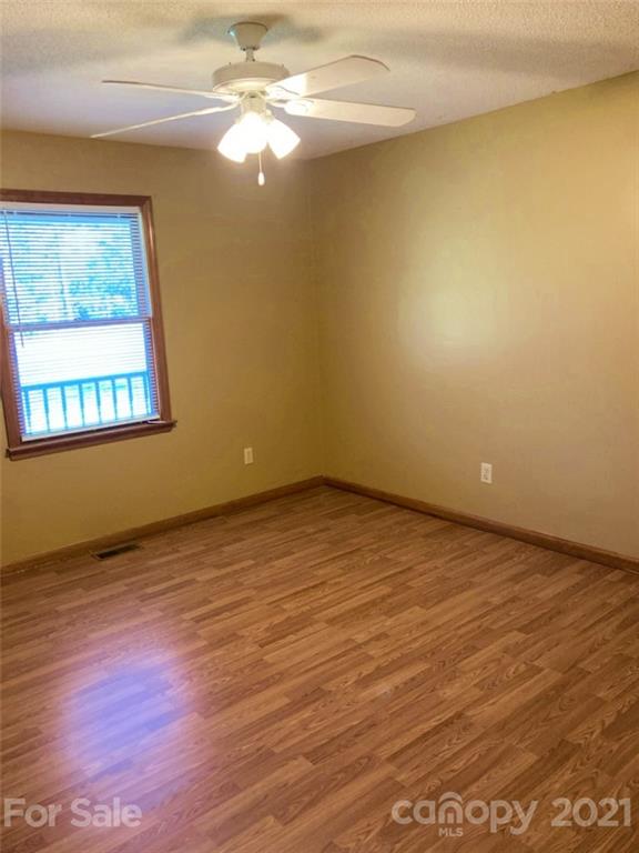 1091 South Beersheba Road Clover, SC 29710 - Photo 14 of 23 a view of an empty room with wooden floor and a window