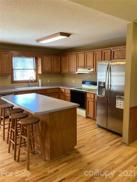 1091 South Beersheba Road Clover, SC 29710 - Photo 5 of 23 a kitchen with stainless steel appliances granite countertop a sink a stove and a refrigerator