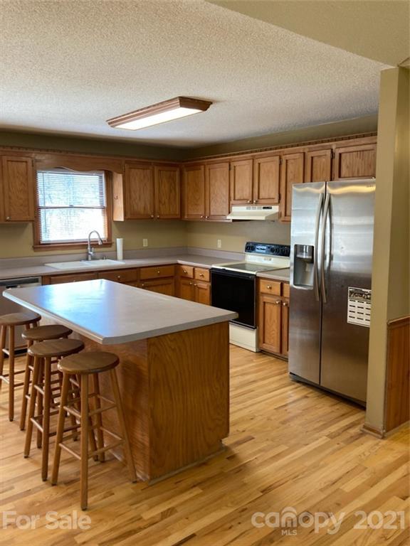 1091 South Beersheba Road Clover, SC 29710 - Photo 6 of 23 a kitchen with stainless steel appliances granite countertop a sink a stove and a refrigerator