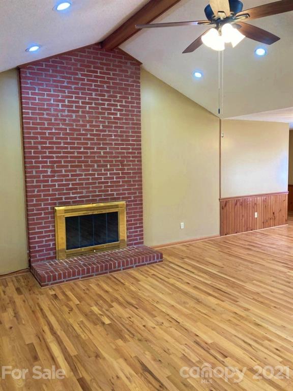 1091 South Beersheba Road Clover, SC 29710 - Photo 10 of 23 a view of empty room with a fireplace and fan