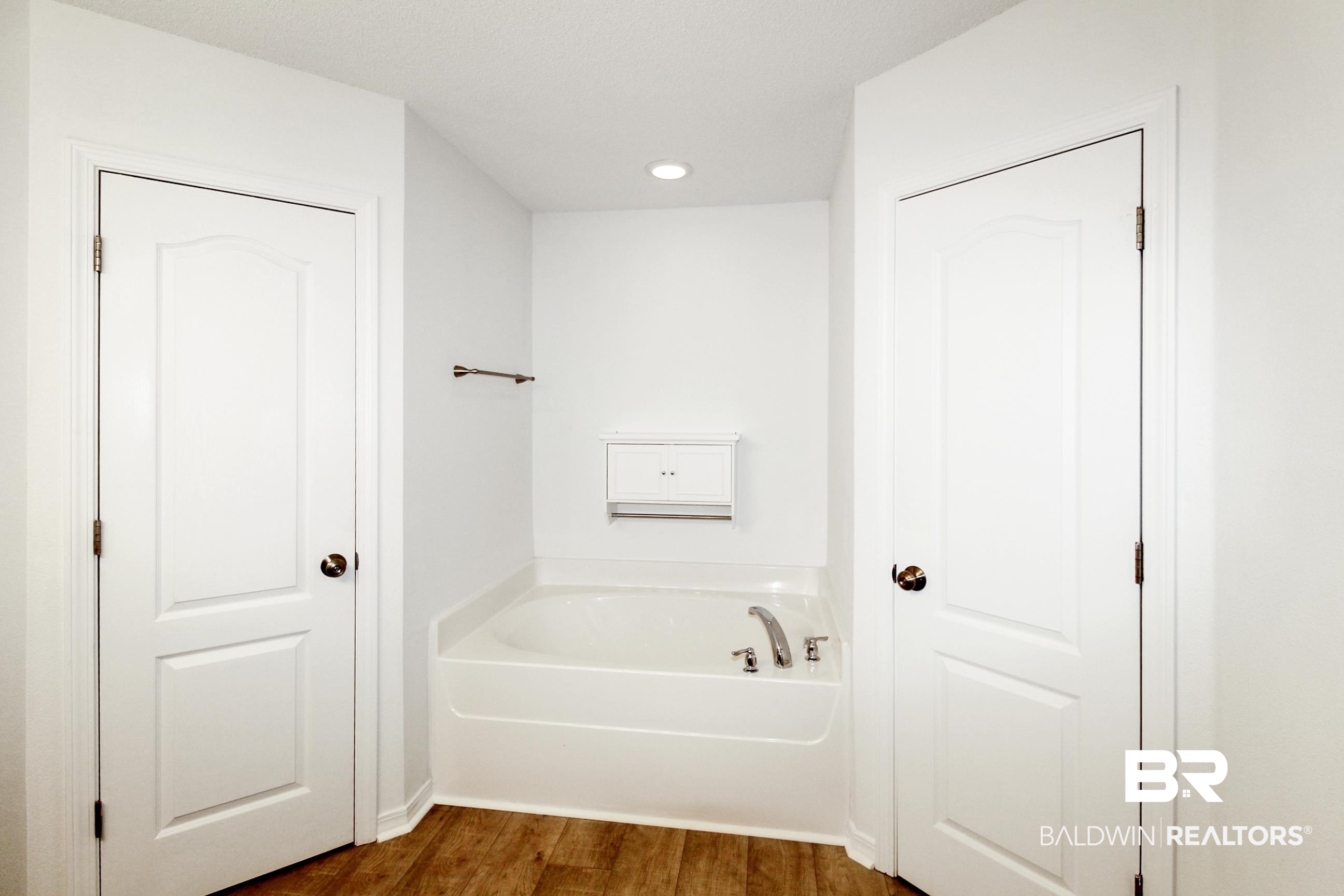 14750 Pawnee Court Foley, AL 36535 - Photo 23 of 34 Full bathroom featuring a garden tub, wood finished floors, and recessed lighting