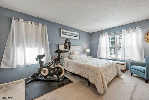 a bedroom with a bed a table and chair