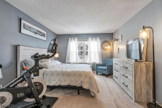 a bedroom with bed and a large mirror