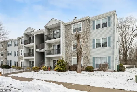 a front view of a residential apartment building with a yard