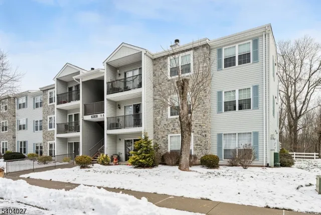 a front view of a residential apartment building with a yard