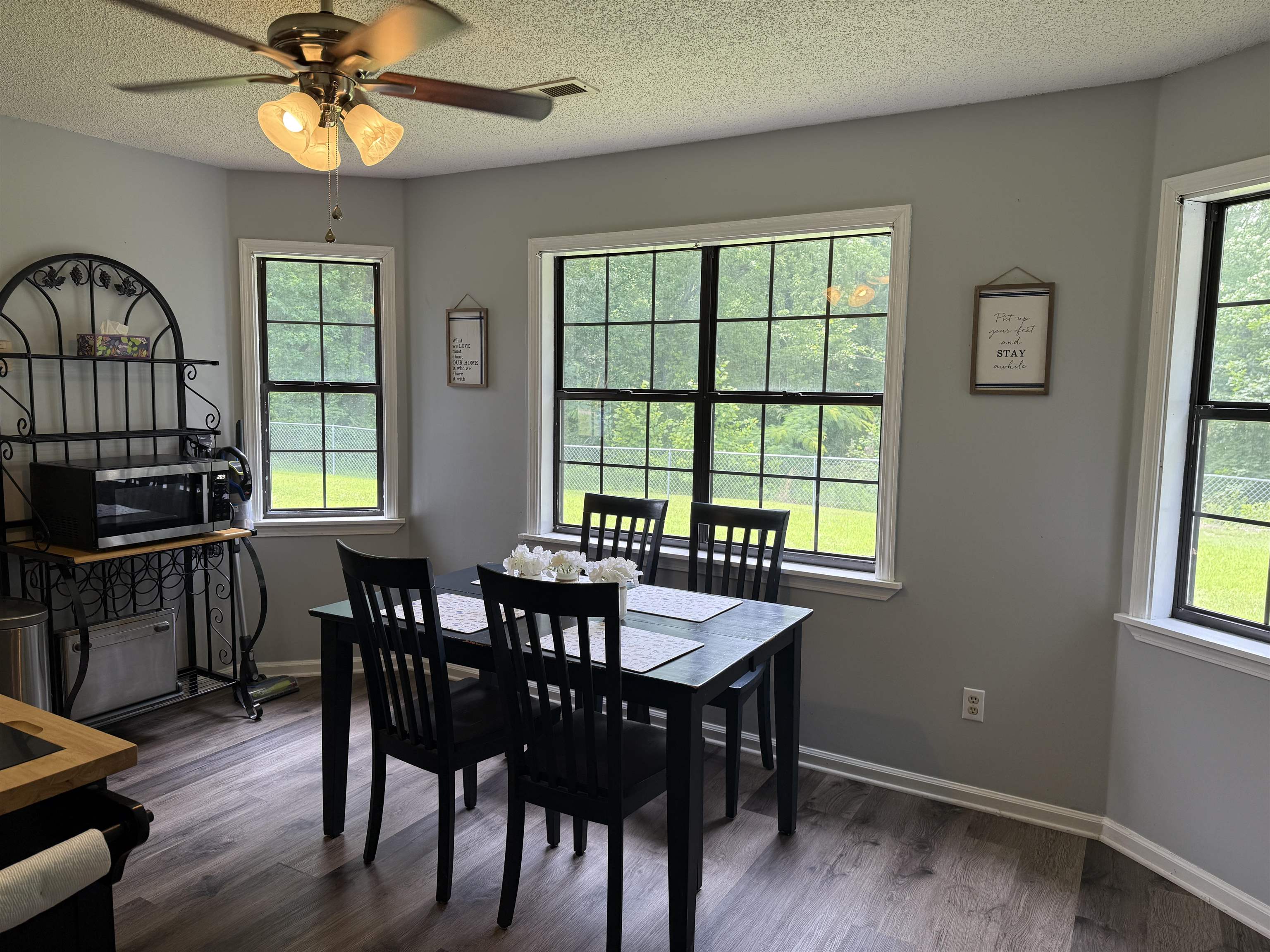 185 Mignon Road Atoka, TN 38004 - Photo 18 of 34 Dining area featuring wood-finish flooring, light gray walls, and multiple grid-paned windows