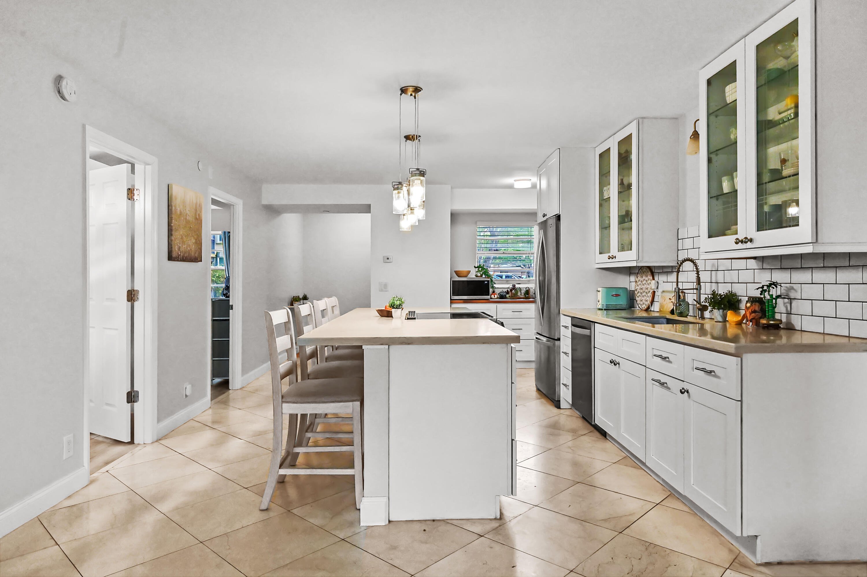 6400 Northwest 2nd Avenue, Unit 124 Boca Raton, FL 33487 - Photo 9 of 33 a kitchen with a sink counter top space and stainless steel appliances