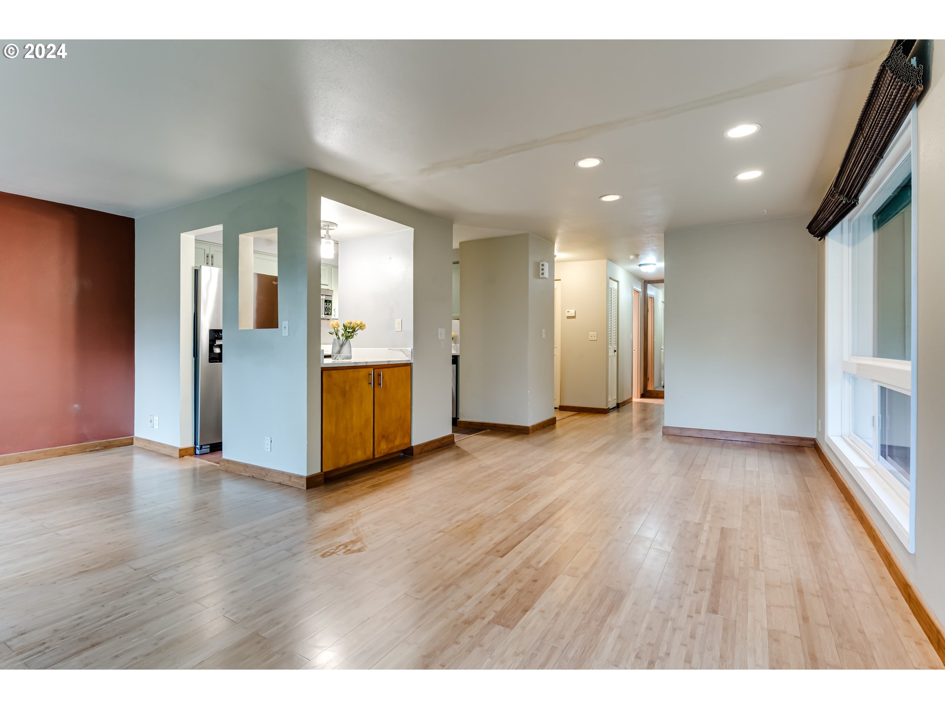 302 Woodcutter Way Eugene, OR 97405 - Photo 11 of 31 a view of an empty room with wooden floor and windows