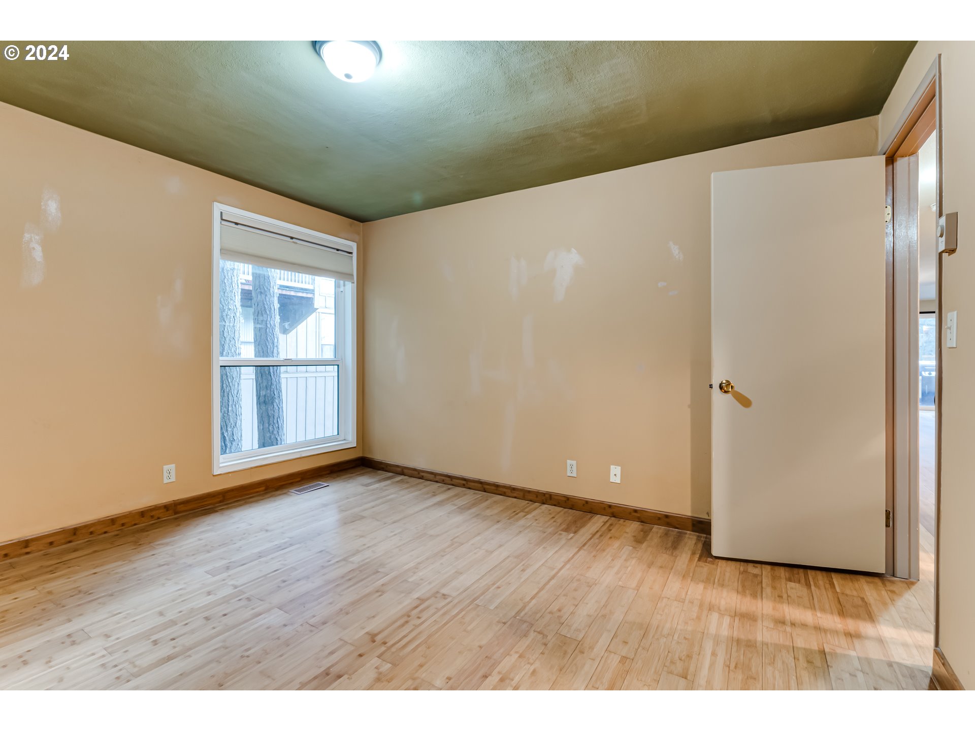 302 Woodcutter Way Eugene, OR 97405 - Photo 15 of 31 a view of an empty room with wooden floor and a window