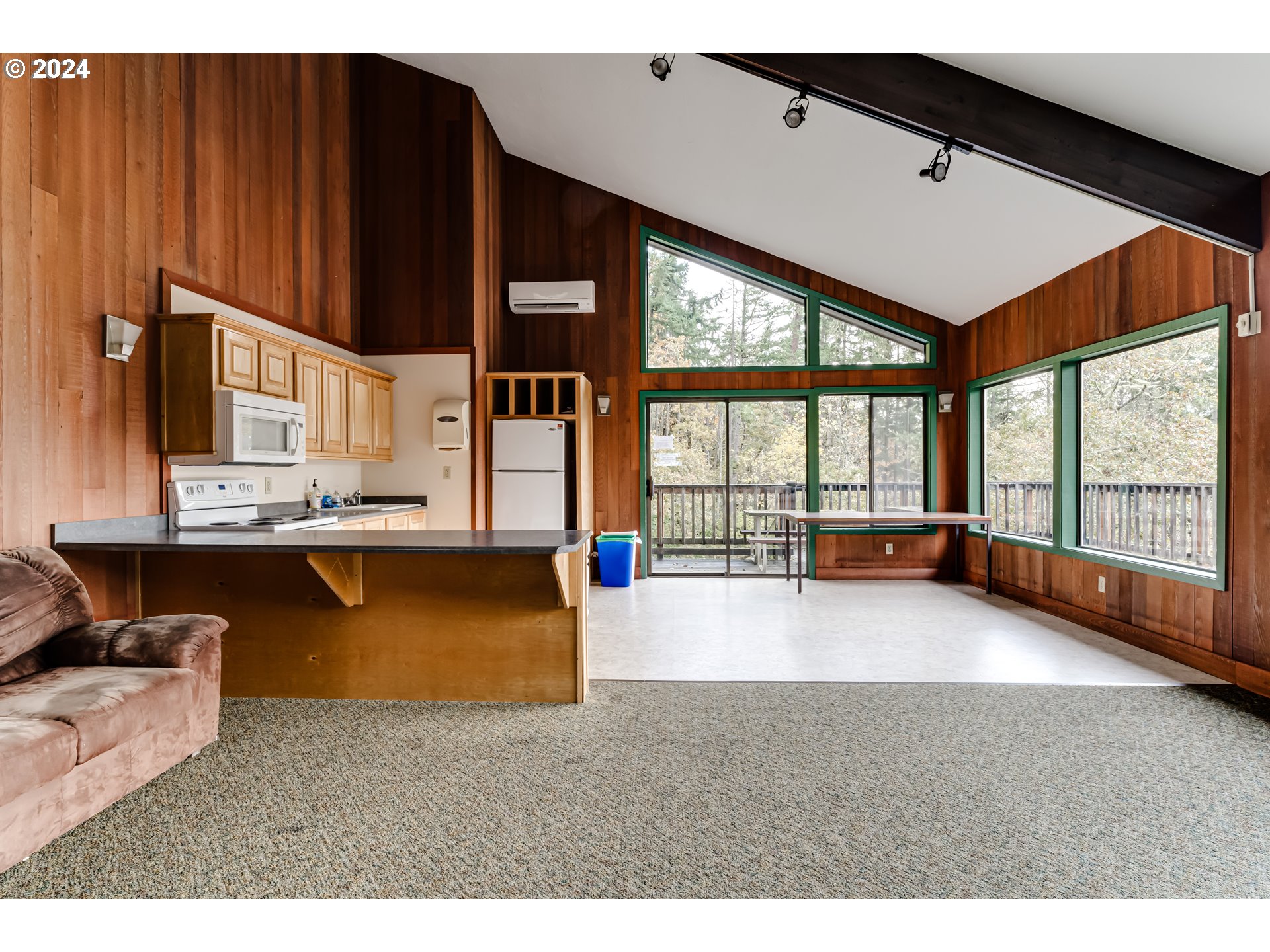 302 Woodcutter Way Eugene, OR 97405 - Photo 25 of 31 a living room with floor to ceiling window and kitchen view