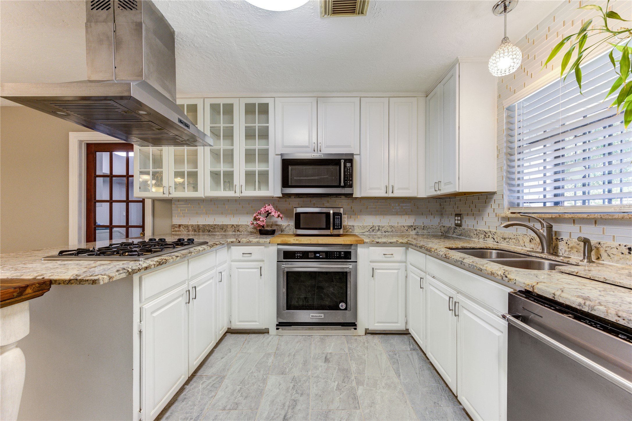 4018 Blalock Road Houston, TX 77080 - Photo 14 of 35 Love to cook? This bright Kitchen Aid appliances, a great range hood and elegant white cabinets with beautiful granite tops.