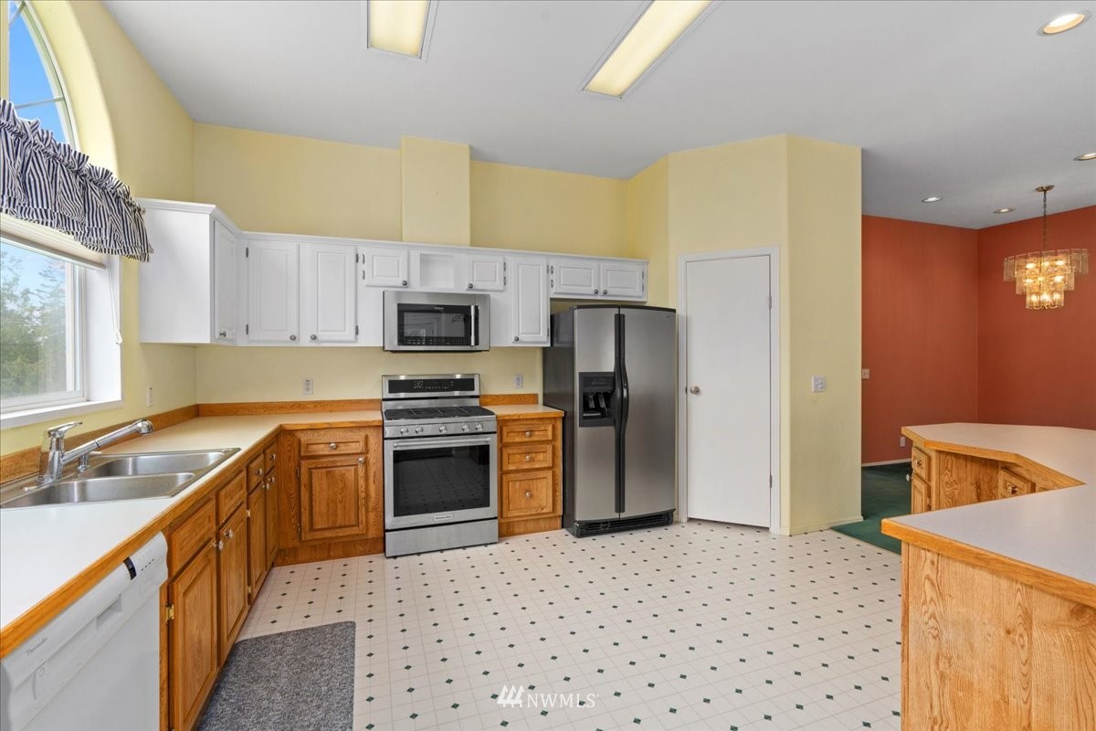 17455 Allen Road Bow, WA 98232 - Photo 10 of 33 a kitchen with a sink a stove top oven a refrigerator and a sink