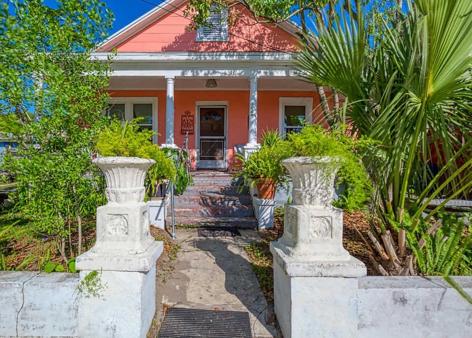 front view of a house with potted plants