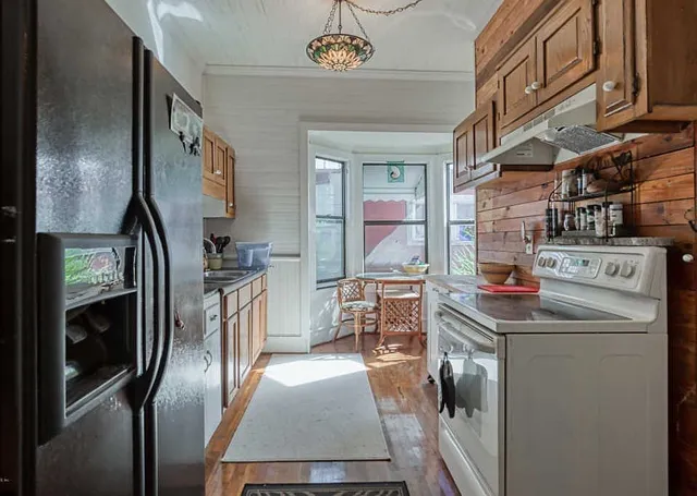 a kitchen with refrigerator and window
