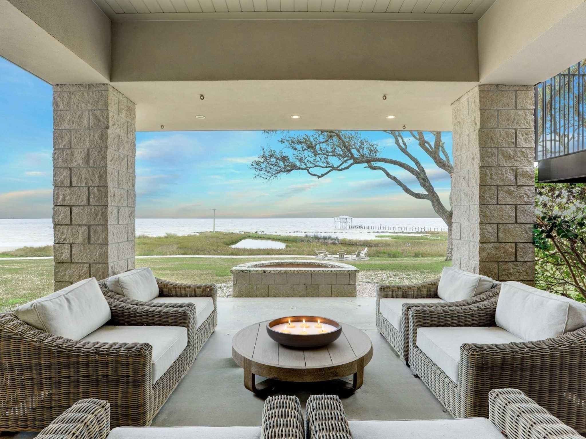 633 Quintana Roo Place Seabrook, TX 77586 - Photo 33 of 47 Outside there are several covered, lounge areas area to enjoy. This seating area offers a gas-plumbed fire pit for cooler days.