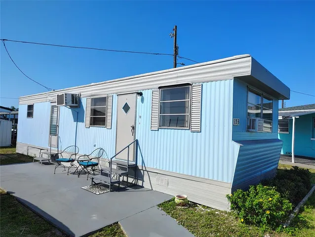 a front view of a house with sitting area