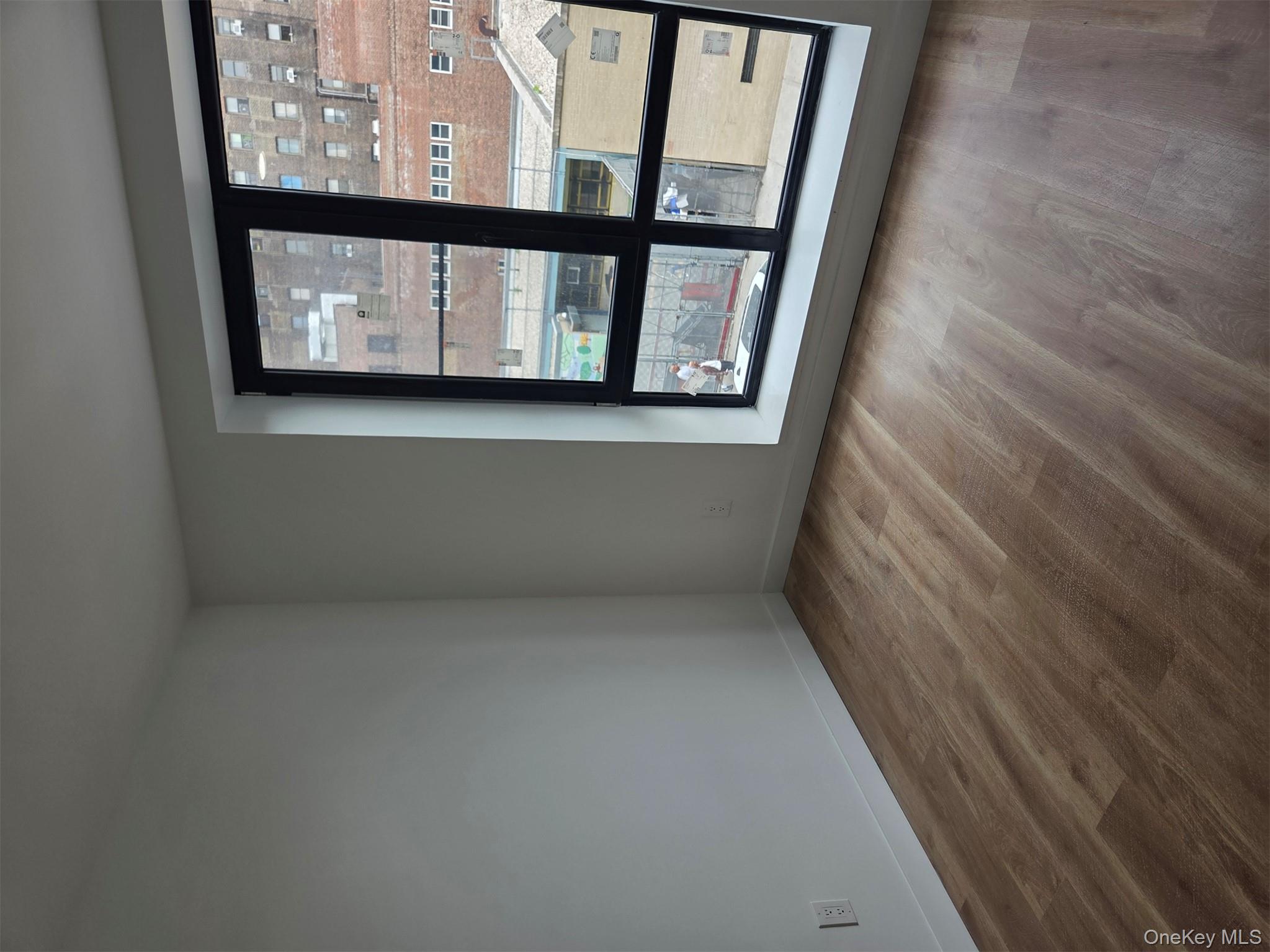132 West 134th Street Manhattan, NY 10030 - Photo 12 of 15 an empty room with wooden floor and windows