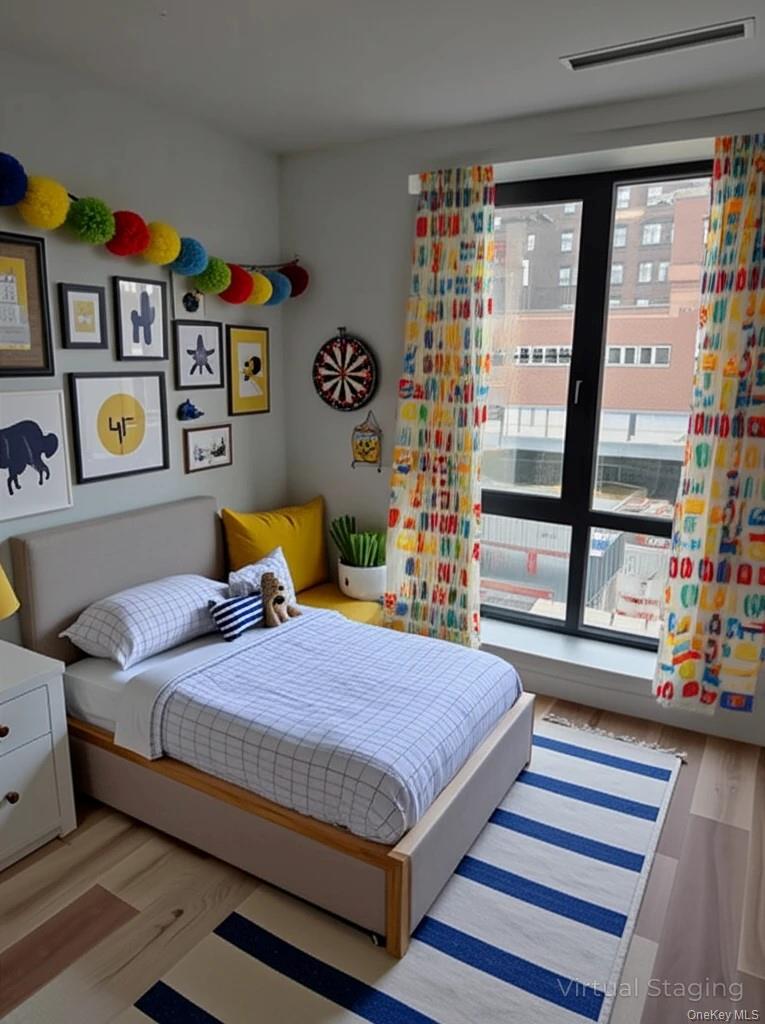 132 West 134th Street Manhattan, NY 10030 - Photo 13 of 15 a bedroom with a bed and a large window