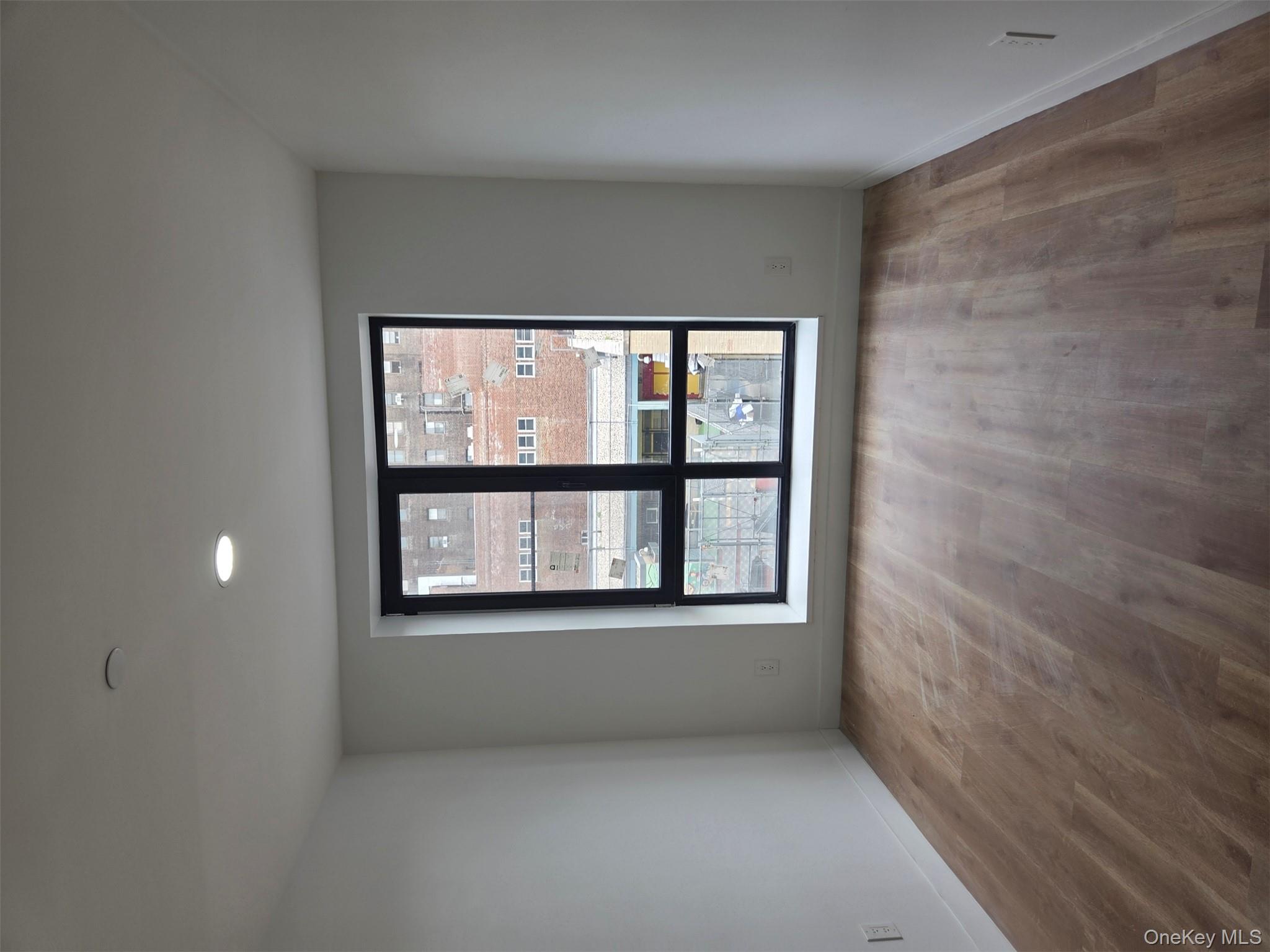 132 West 134th Street Manhattan, NY 10030 - Photo 8 of 15 wooden floor in an empty room with a window