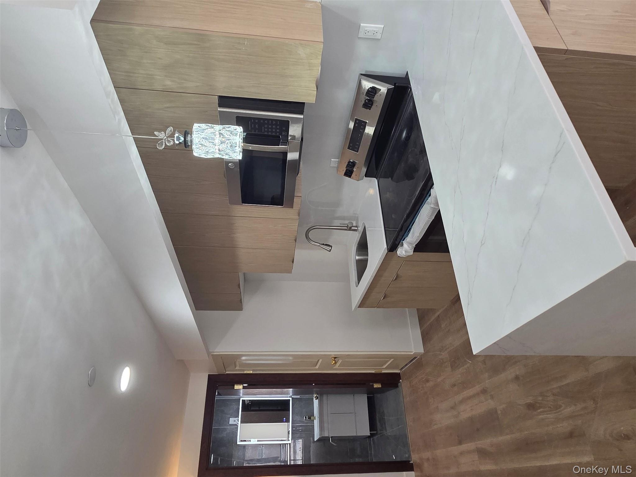 132 West 134th Street Manhattan, NY 10030 - Photo 9 of 15 a kitchen with stainless steel appliances a sink stove and refrigerator