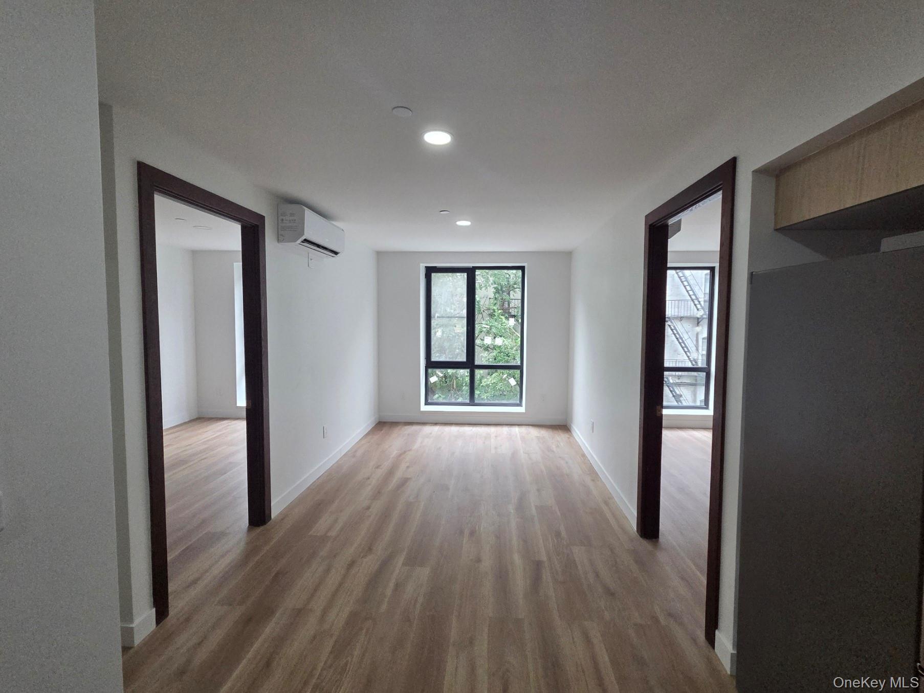 132 West 134th Street Manhattan, NY 10030 - Photo 10 of 15 wooden floor in an empty room with a window