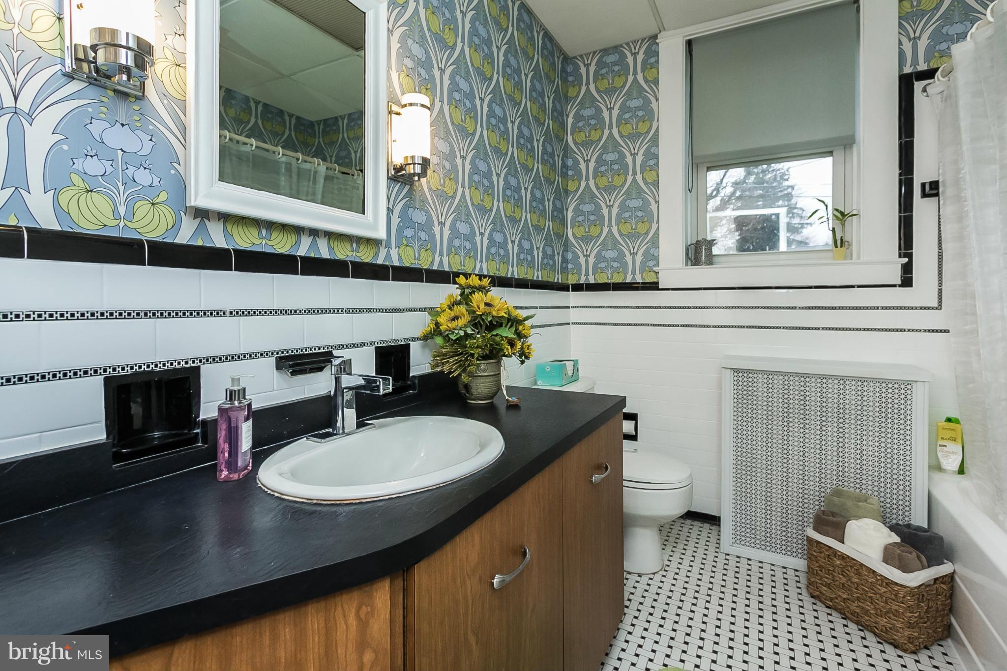 238 Ridgeway Road Baltimore, MD 21228 - Photo 19 of 30 a bathroom with a sink a toilet and a mirror