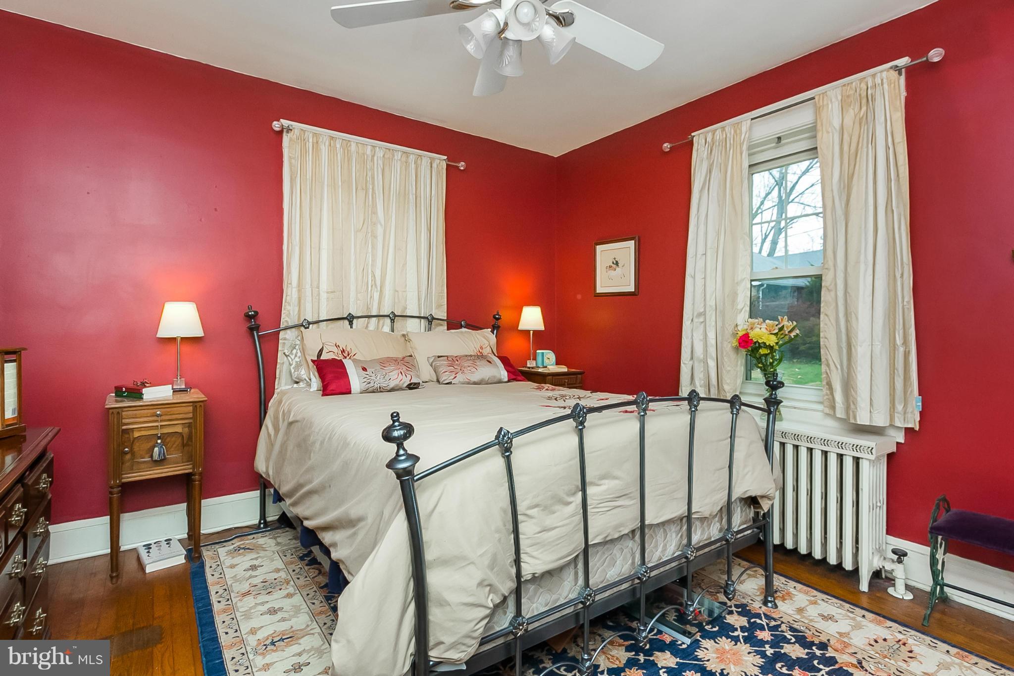 238 Ridgeway Road Baltimore, MD 21228 - Photo 20 of 30 a bedroom with a bed and a chandelier