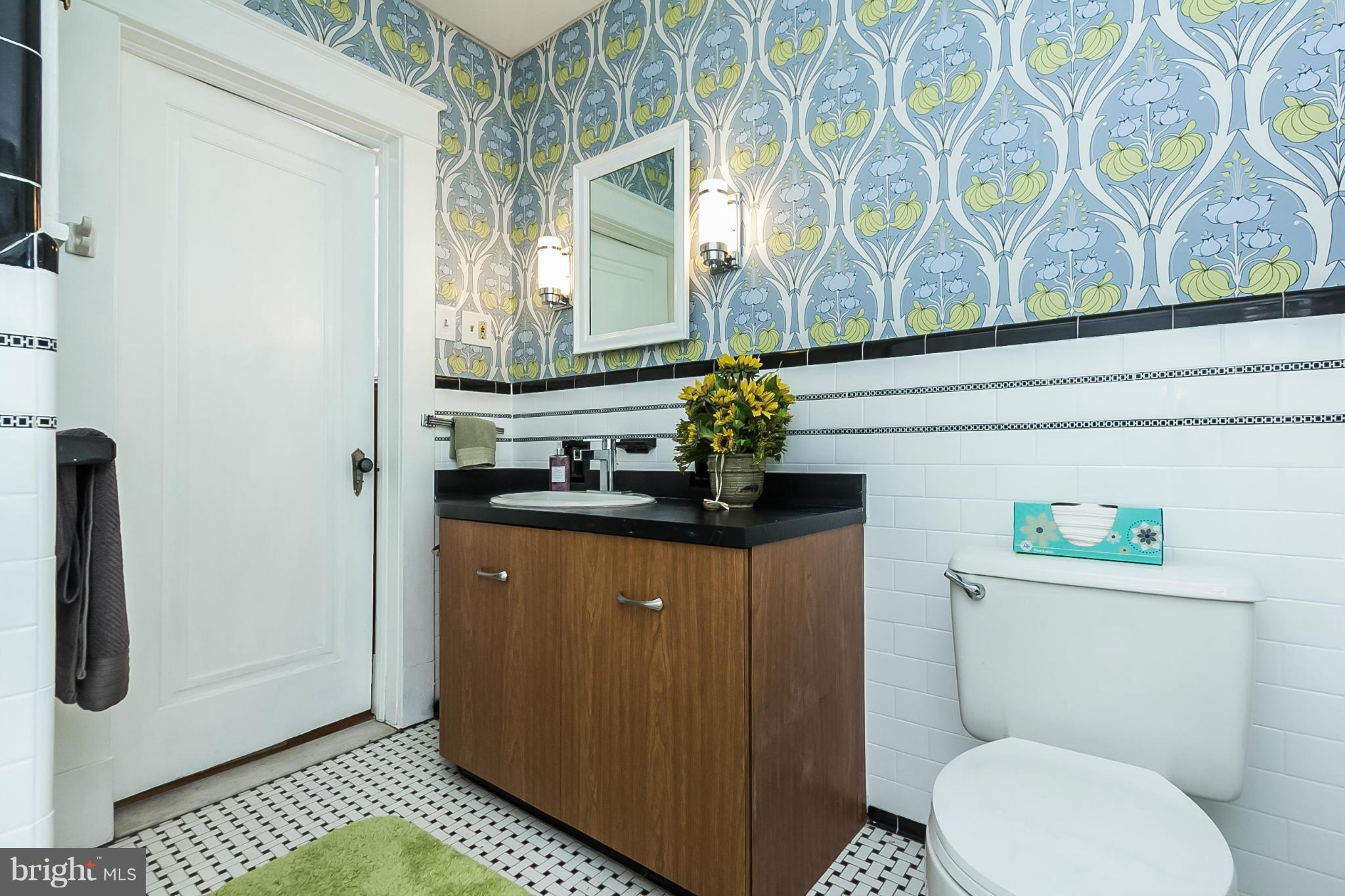 238 Ridgeway Road Baltimore, MD 21228 - Photo 21 of 30 a bathroom with a toilet a sink and a window