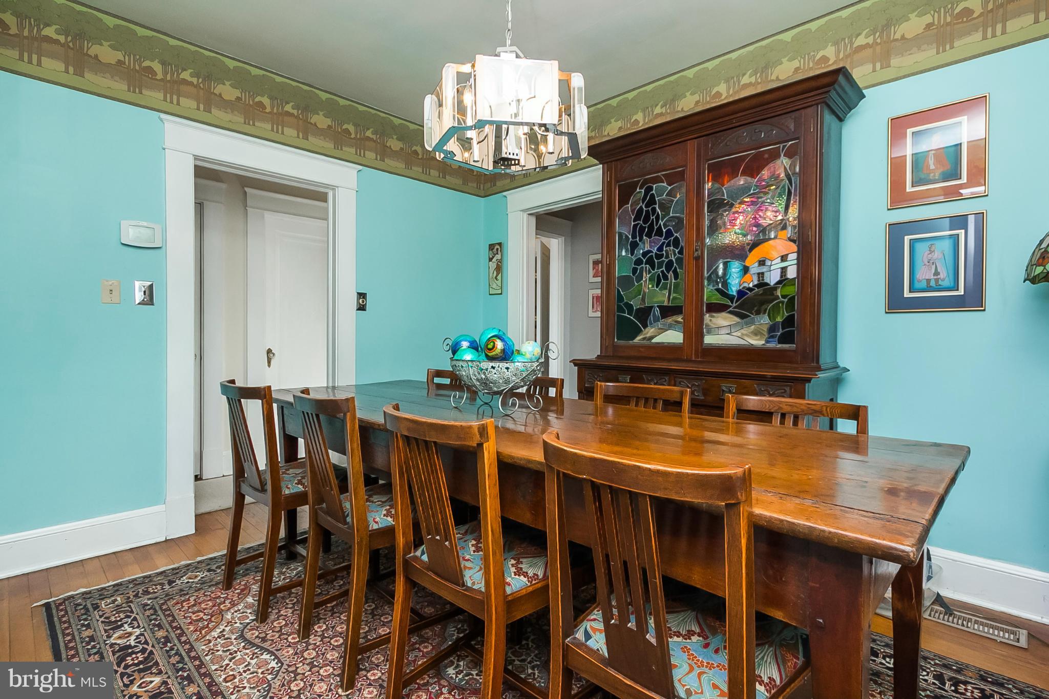238 Ridgeway Road Baltimore, MD 21228 - Photo 6 of 30 a view of a dining room with furniture wooden floor and a chandelier