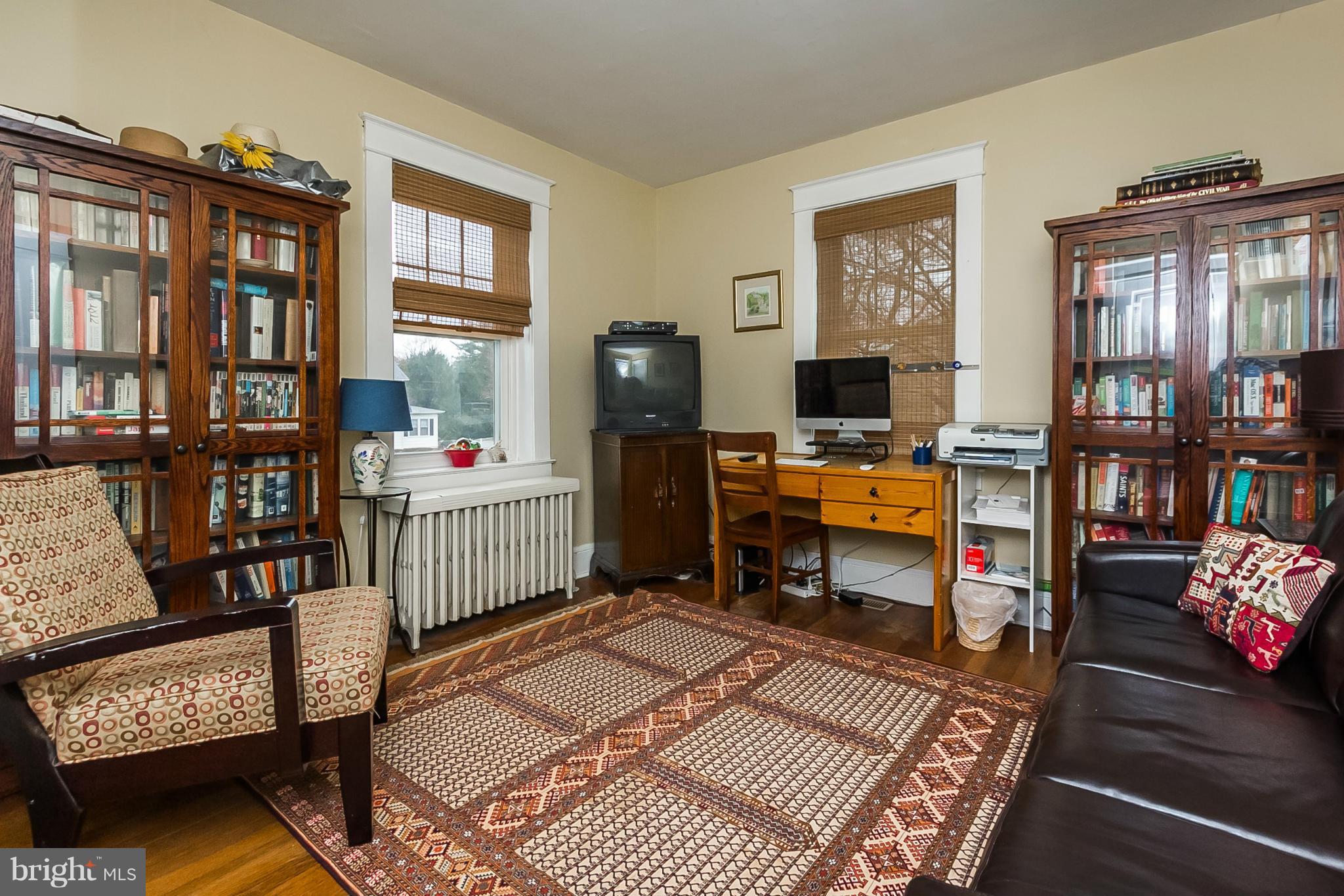 238 Ridgeway Road Baltimore, MD 21228 - Photo 7 of 30 a bedroom with furniture and a fireplace