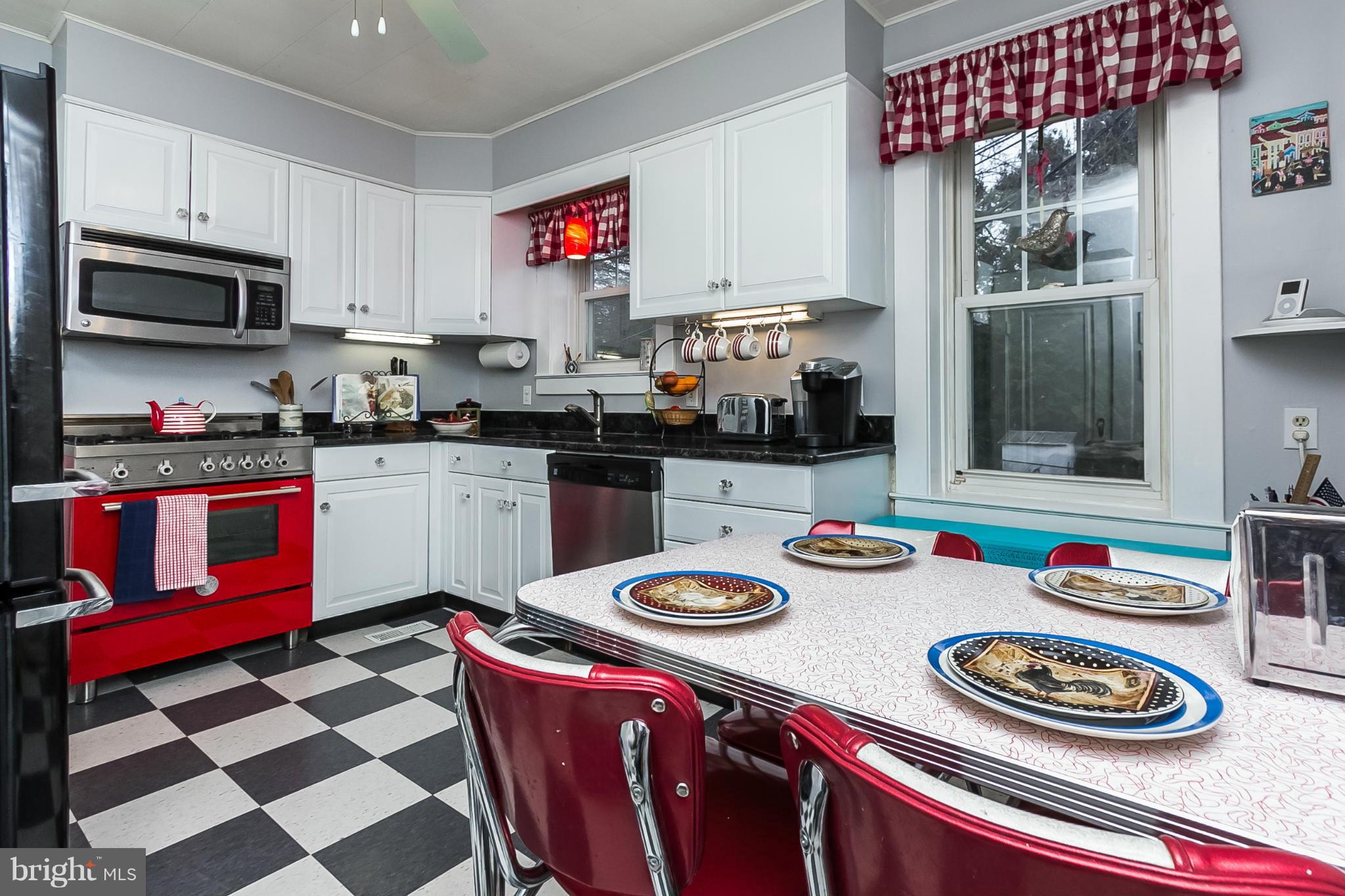 238 Ridgeway Road Baltimore, MD 21228 - Photo 8 of 30 a kitchen with stainless steel appliances granite countertop a dining table and chairs