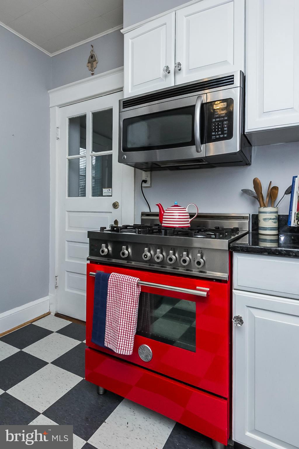 238 Ridgeway Road Baltimore, MD 21228 - Photo 10 of 30 a kitchen with stainless steel appliances granite countertop a stove a microwave cabinets and a sink