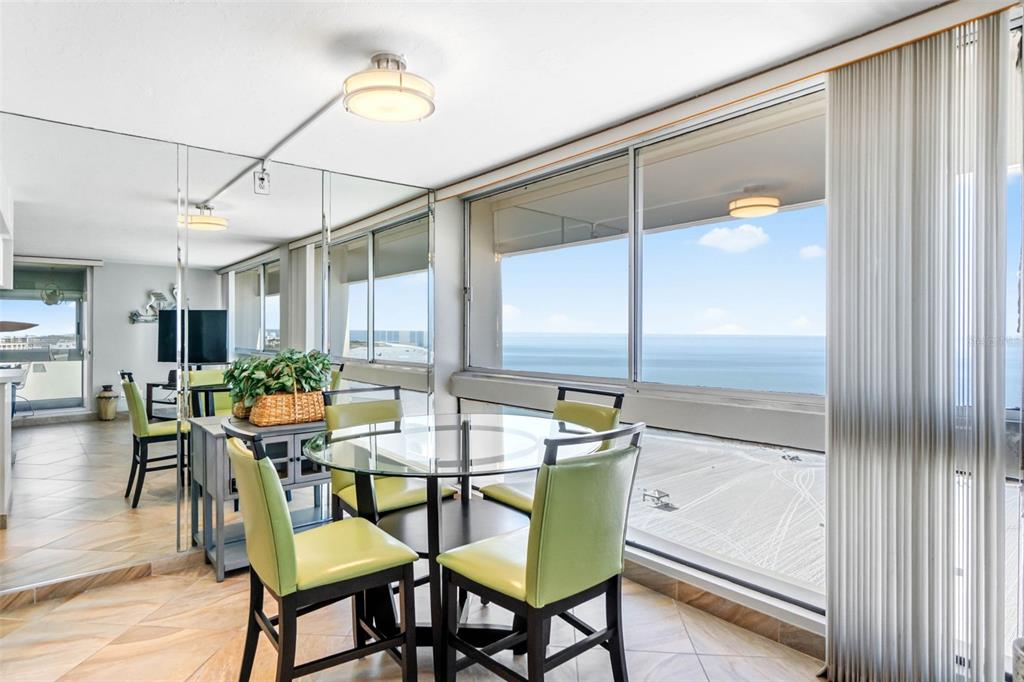 5966 Midnight Pass Road, Unit G113 Sarasota, FL 34242 - Photo 13 of 39 a view of a dining room with furniture and wooden floor