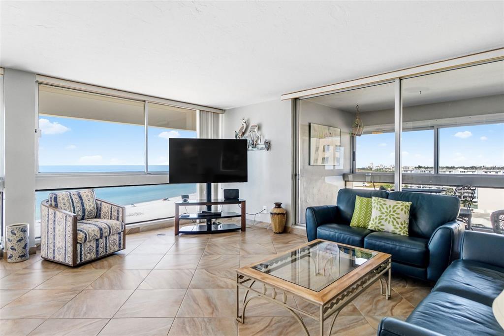 5966 Midnight Pass Road, Unit G113 Sarasota, FL 34242 - Photo 15 of 39 a living room with furniture and a flat screen tv