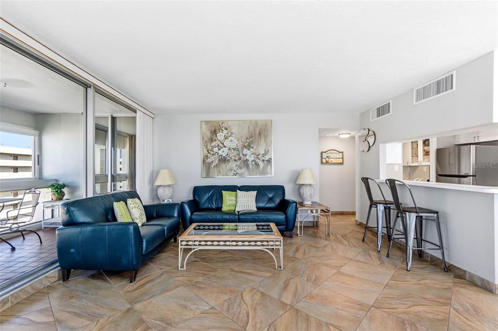 5966 Midnight Pass Road, Unit G113 Sarasota, FL 34242 - Photo 17 of 39 a living room with furniture and a table