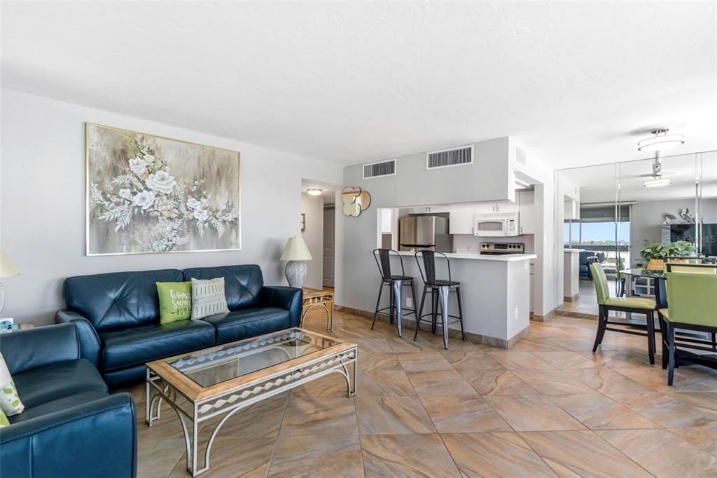 5966 Midnight Pass Road, Unit G113 Sarasota, FL 34242 - Photo 18 of 39 a living room with furniture and kitchen view