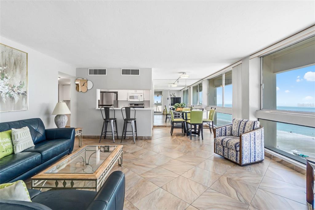 5966 Midnight Pass Road, Unit G113 Sarasota, FL 34242 - Photo 19 of 39 a living room with furniture and a table