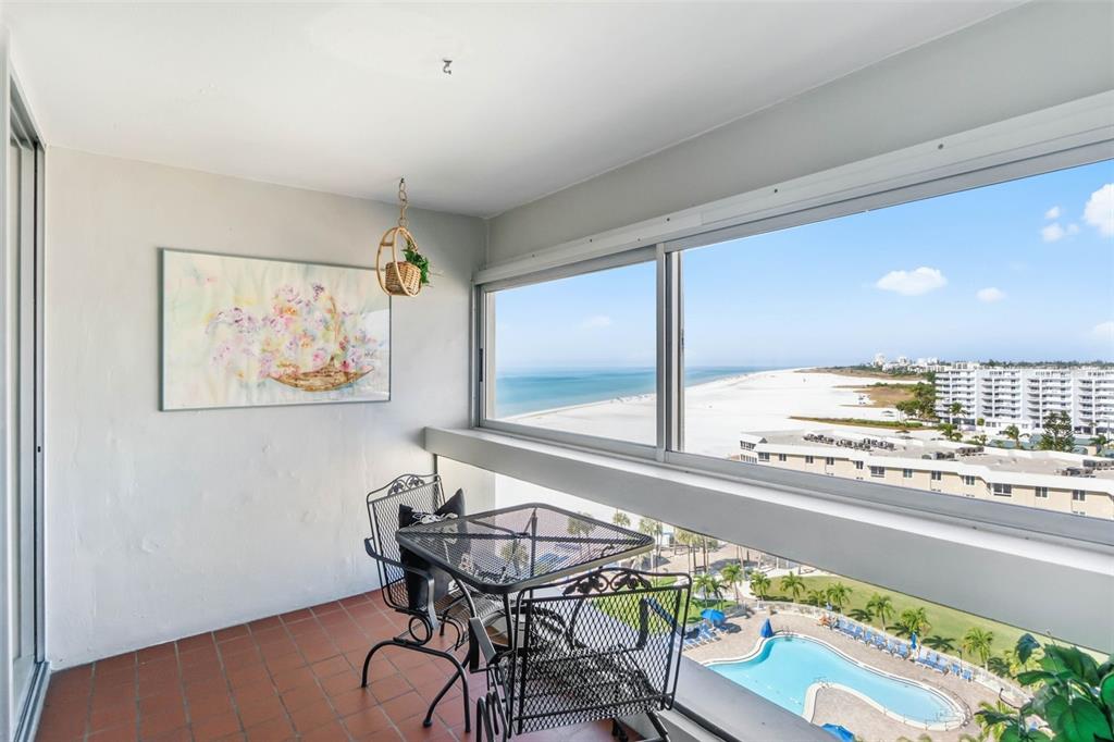 5966 Midnight Pass Road, Unit G113 Sarasota, FL 34242 - Photo 21 of 39 a view of a dining room with furniture one side kitchen view and wooden floor