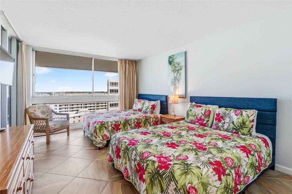 5966 Midnight Pass Road, Unit G113 Sarasota, FL 34242 - Photo 22 of 39 a bedroom with a bed and window