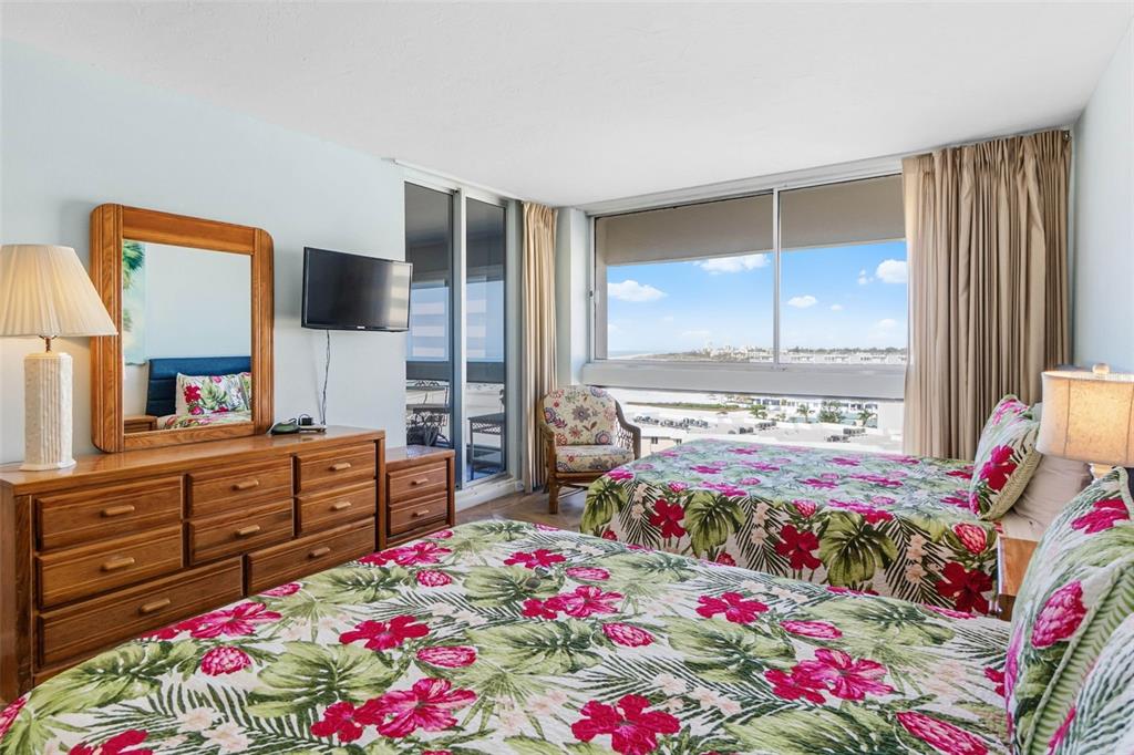 5966 Midnight Pass Road, Unit G113 Sarasota, FL 34242 - Photo 23 of 39 a bed room with a bed dresser and a window