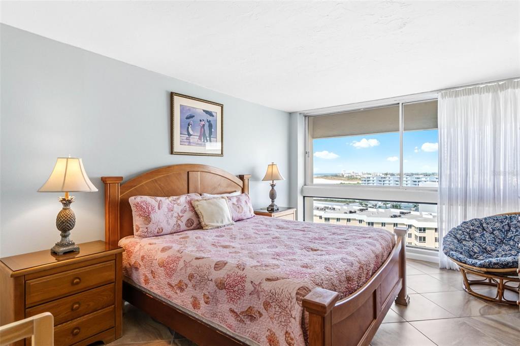 5966 Midnight Pass Road, Unit G113 Sarasota, FL 34242 - Photo 28 of 39 a bedroom with a bed and wooden floor