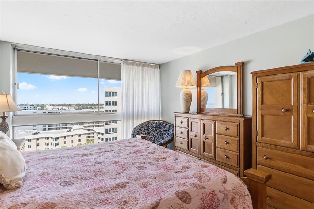 5966 Midnight Pass Road, Unit G113 Sarasota, FL 34242 - Photo 29 of 39 a bedroom with a bed dresser and a window