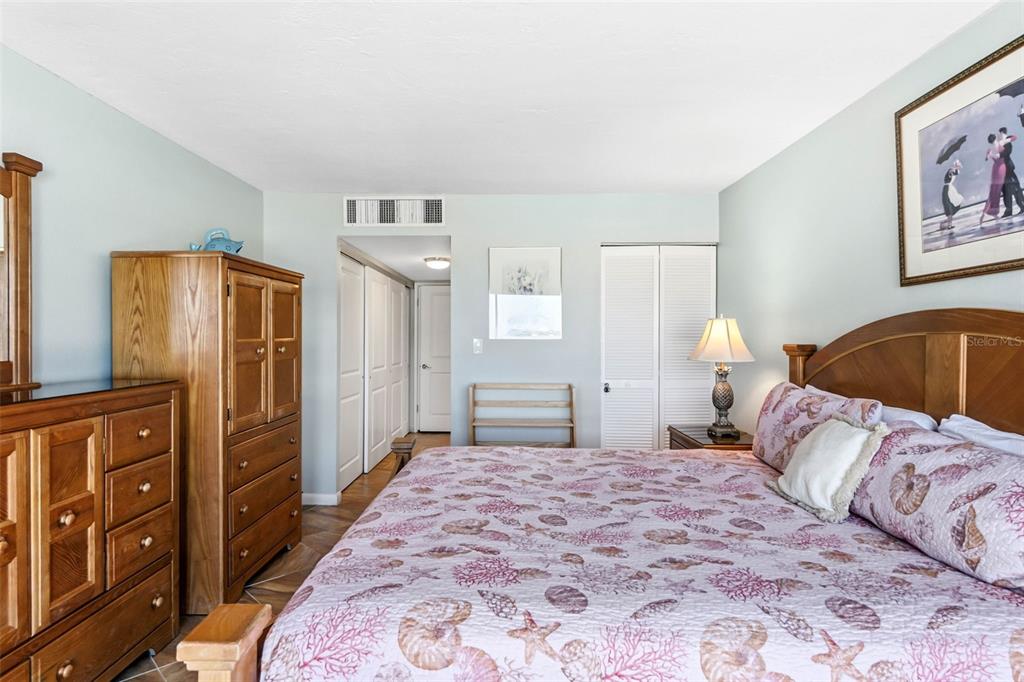5966 Midnight Pass Road, Unit G113 Sarasota, FL 34242 - Photo 31 of 39 a bedroom with a bed and cabinets