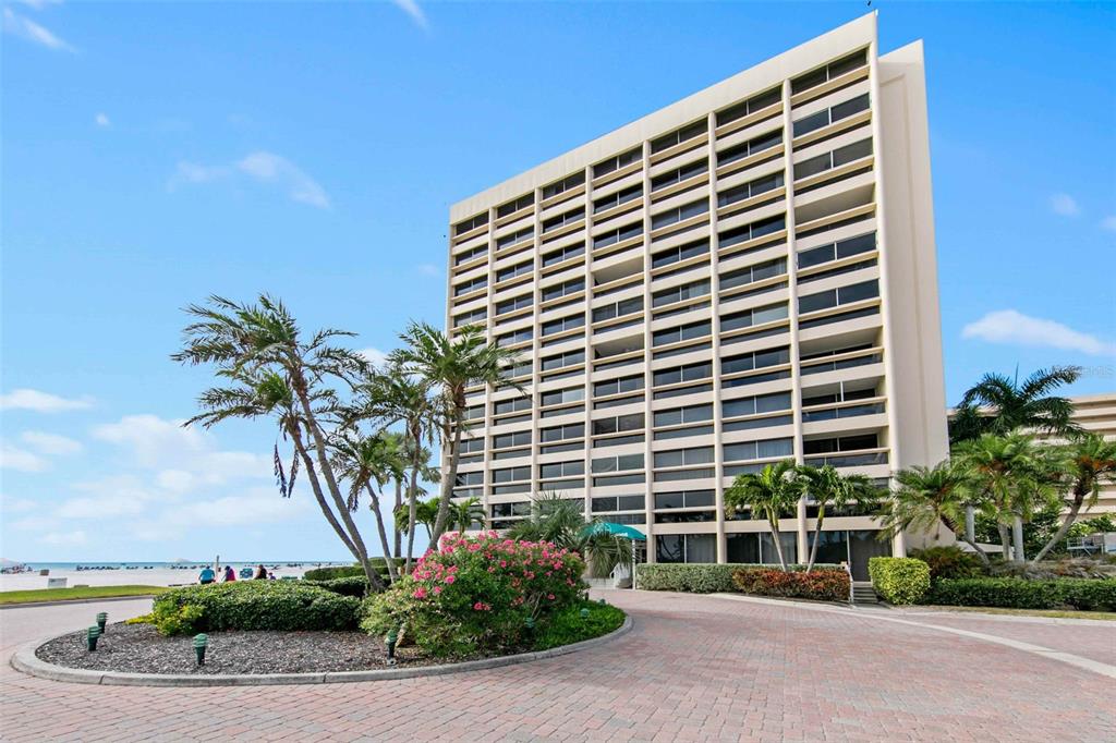 5966 Midnight Pass Road, Unit G113 Sarasota, FL 34242 - Photo 39 of 39 a front view of a building with a garden