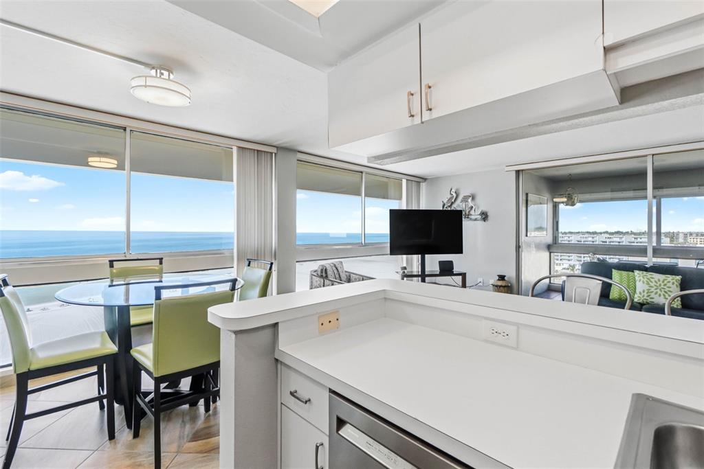 5966 Midnight Pass Road, Unit G113 Sarasota, FL 34242 - Photo 8 of 39 a room with furniture a flat screen tv and a sink